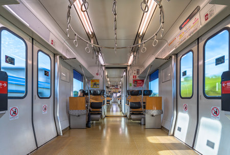 kyushu, japan - december 10 2021: Interior of the commuter train of Kyushu railway company, the JR Kyushu BEC819 series with grab handles in circle moving around Nagasaki and isahaya stations.のeditorial素材