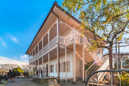 nagasaki, kyushu - december 13 2021: British Georgian two-storied residence built by thomas blake glover in Meiji era in the Glover Garden designed with a fretworked verandah archway with a balustradeのeditorial素材