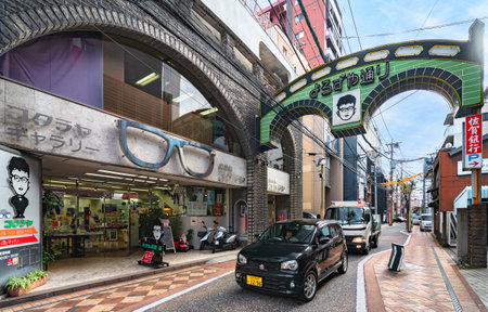 nagasaki, kyushu - december 12 2021: Car traffic passing below the gate shaped as the Megane or Spectacles bridge of Nakashima river in the Yorozuya shopping street in front of the kokuraya optician.のeditorial素材
