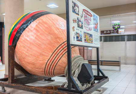 Sasebo, Kyushu - Dec 08 2022: A giant Japanese wooden 200kg spinning top called Sasebo-Goma with its yoma-himo rope created in 1997 for the Kunchi festival held in autumn at Kameyama Hachimangu Shrineのeditorial素材