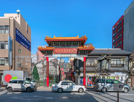 nagasaki, kyushu - dec 12 2022: Car traffic in front the landmark of Nagasaki Shinchi Chinatown, the South Gate showcasing the unique cultural fusion of Chinese and Japanese influences.のeditorial素材