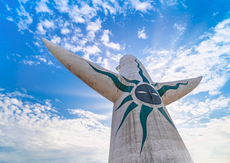 japan, osaka - dec 4 2022: Low-angle shot of the backside of the Japanese Tower of the Sun or taiyou no tou created by Taro Okamoto for Expo '70 decorated with a black sun face soar into the blue skyのeditorial素材