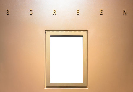 Mock-up of a cinema wall with the word screen in metallic letters lit from above and a blank white...