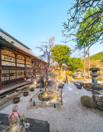 saitama, chichibu - mar 26 2023: Inner garden along the main kondo hall covered by votive slips named senjafuda in the buddhist Chosen-in Buddhist temple decorated with a statue of Enmei Jizo.のeditorial素材