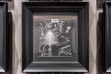 tokyo, japan - sep 08 2023: Black shikishi board framed and signed by the voice actresses and actors, the director and the mangaka of the Japanese anime City Hunter Angel Dust on a cinema wall.のeditorial素材