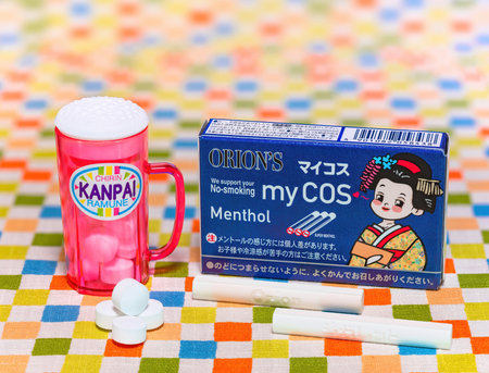 tokyo, japan - feb 17 2024: Japanese confectionery manufacturer Orion's dagashi cheap penny candies depicting a pack of cocoa cigarettes and a mug of beer for children pretending to smoke or drink.のeditorial素材