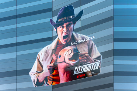 tokyo, japan - apr 28 2024: Toho cinema facade sticker of Japanese actor Ryohei Suzuki as Ryo Saeba in the Netflix film "City Hunter" doing a gag while riding a horse like his "mokkori" or "erection".のeditorial素材