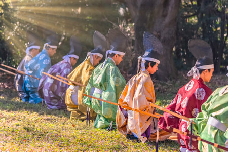 tokyo, yoyogi - jan 13 2024: Archers dressed in kimono wearing eboshi hats perform a traditional Japanese Momoteshiki archery ritual in Meiji Jingu Shrine preserving a cultural heritage of Japan.のeditorial素材
