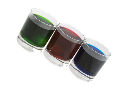 Three glasses with multi-coloured cocktails isolated over white background