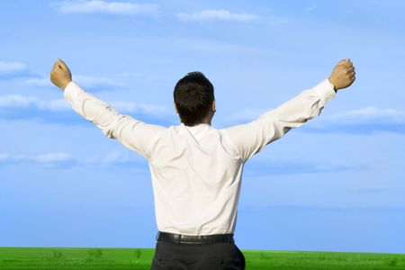 businessman take energy from nature in the meadow with dark blue skyの写真素材