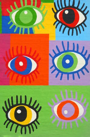 Colorful graffiti spray painted funny eyes on the decorated  brick wall - makes a great background or backdropの写真素材