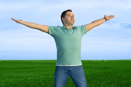 man take energy from nature in the meadow with dark blue skyの写真素材