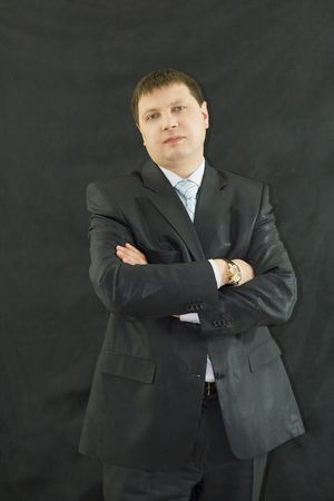 Closeup portrait of  handsome businessman over black backgroundの写真素材