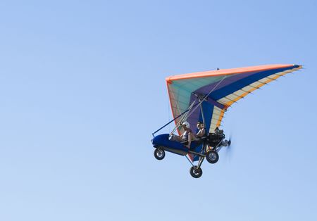 Extreme flight on deltaplane in a blue skyの写真素材