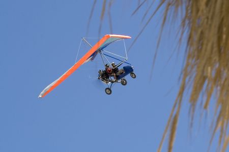 Extreme flight on deltaplane in a blue sky