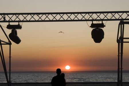 Silhouette man and woman again sunset  の写真素材