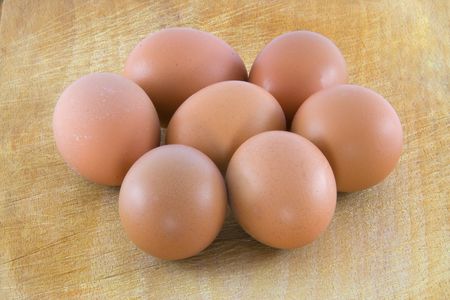 Many fresh rural eggs on the wooden surfaceの写真素材