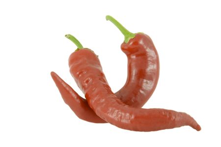 Two red hot chili peppers over white backgroundの写真素材