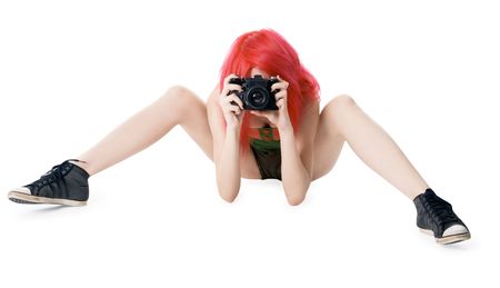 Red-hair young girl with photocamera isolated on whiteの写真素材