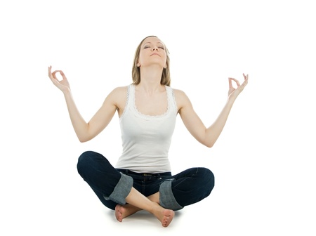 Portrait of pretty young woman doing yoga exercise on the floorの写真素材