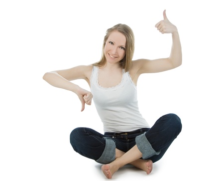 lovely woman in jeans shouing thumbs up and thumbs downの写真素材