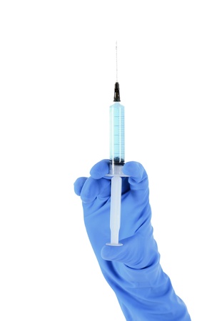 Hand in glove with medical syringe.の写真素材
