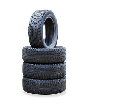 The stack of four winter new tires over whiteの写真素材