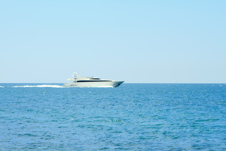 Luxury white speed yatch in open waters full aheadの写真素材