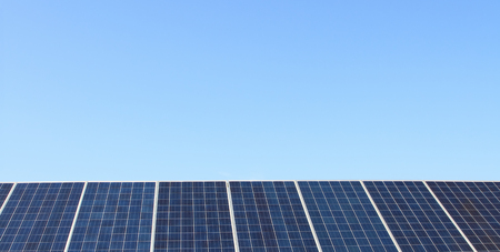 Solar panels over blue sky