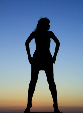 Silhouette of dancing girl in the sunsetの写真素材