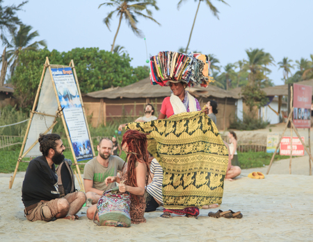 Goa, India - February 15, 2016: Woman seller at the beach Arambol offers its goods to touristsのeditorial素材