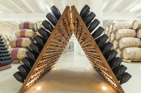 stacked of old wine bottles in the cellarの写真素材