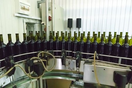 Bottling and sealing conveyor line at winery factoryの写真素材