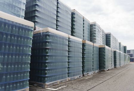 A lot of wrapped empty beer bottles on palletsの写真素材