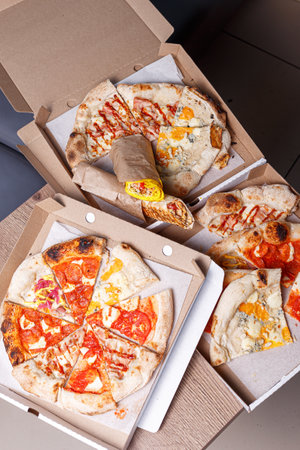 Different pizzas in cardboard boxes on the table. Top view.の写真素材