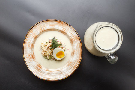 Creamy sour cream soup with chicken, egg and dillの写真素材