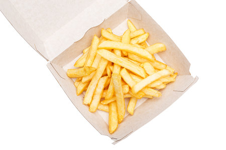 Golden French fries in paper box isolated on white background, top view