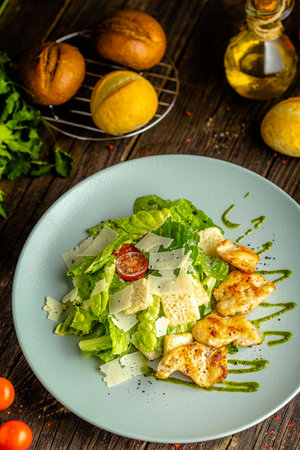 Caesar salad with chicken and cheese on wooden table. Healthy foodの写真素材