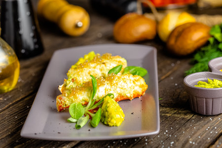 Fried fish fillet with vegetables and spices on a wooden backgroundの写真素材