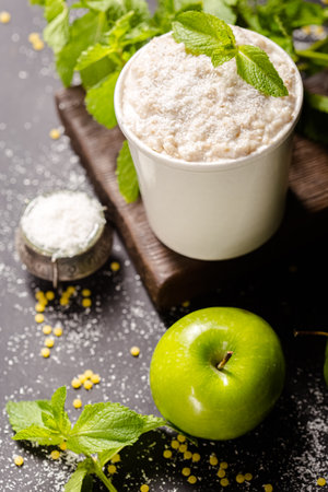 Coconut milk with fresh green apple on dark wooden background.の写真素材