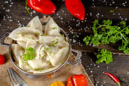 Boiled dumplings stuffed with meat and vegetables on wooden backgroundの写真素材