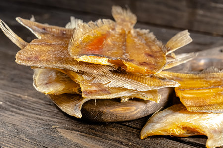Dried salted fish on a wooden background. Close up.