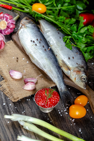 Salted herring with parsley and tomatoes on a wooden backgroundの写真素材