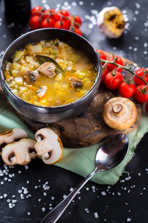 Mushroom soup with champignons and potatoes in a bowlの写真素材