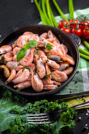 Fresh shrimps with herbs and spices on a black background.の写真素材