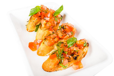 Bruschetta with tomato, mozzarella and basil. Isolated over white backgroundの写真素材