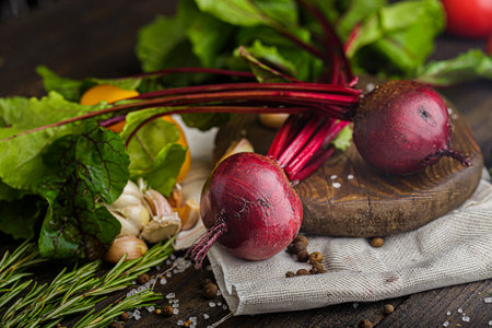 Fresh beetroot with garlic, herbs and spices on a wooden tableの写真素材