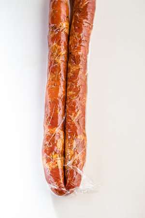 Smoked sausage on a white background in a vacuum package. Isolateの写真素材