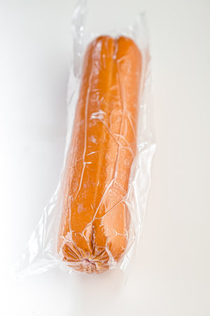 Sausage in plastic bag on white background. Isolated.の写真素材