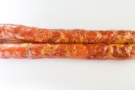 smoked sausage on white background. smoked sausage on a white backgroundの写真素材